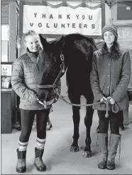  ?? DAVID H. BROW/THE LOWELL SUN VIA AP ?? In this undated photo, Jane Kirby, 17, of Tewksbury, Mass., right, joins fellow volunteer Natalie Claman, 16, of Andover, with Trial, one of the horses at Tewksbury’s Strongwate­r Farm. The nonprofit offers a variety of therapeuti­c services and programs...
