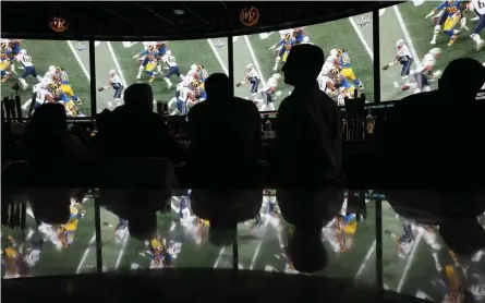  ?? AP FILE ?? WANT TO BET? People watch Super Bowl LIII at the Westgate Superbook sports book on Feb. 3, 2019, in Las Vegas. A measured attached to an economic developmen­t bill before the state Legislatur­e would expand sports betting options.