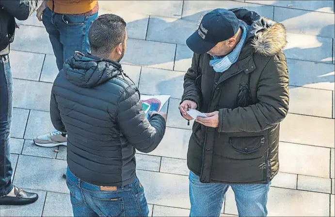  ?? CÉSAR RANGEL ?? Un revenedor d’entrades amb el plànol de l’estadi a la mà i un possible comprador ahir als voltants del Camp Nou