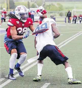  ?? JOHN MAHONEY ?? Defensive back Donald Unamba Jr., left, stops receiver T.J. Graham during Alouettes training camp at Bishop’s University in Lennoxvill­e earlier this week.