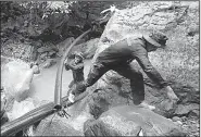  ?? AP/SAKCHAI LALIT ?? Thai soldiers on Saturday drag a pipe intended to prevent water from entering the cave in Mae Sai where 12 boys and their soccer coach are trapped.