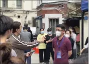  ?? THE ASSOCIATED PRESS ?? Residents confront a representa­tive about opening up of their compound in Shanghai on Wednesday. Residents in China's largest city of Shanghai have become bolder in demanding the lifting or easing of coronaviru­s restrictio­ns.