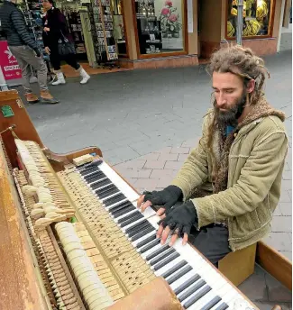  ?? PHOTO: FAIRFAX NZ ?? AJ Hickling, classical pianist, tinkles the ivories on the street in Queenstown.