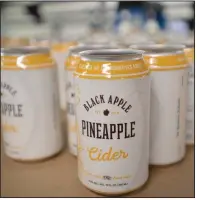  ?? (NWA Democrat-Gazette/Andy Shupe) ?? Empty cans for Black Apple pineapple cider sit before being filled Tuesday in Springdale.