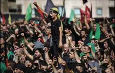  ??  ?? Lebanese Shiite supporters of Hezbollah shout slogans against the U.S and Israel during activities marking the holy day of Ashoura, in southern Beirut, Lebanon, on Sunday. AP PHOTO/HASSAN AMMAR