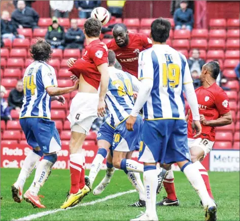  ?? PICTURES: Media Image Ltd ?? LEAP OF FAITH: Barnsley’s Jean Yves-M’voto jumps highest in a crowded penalty area