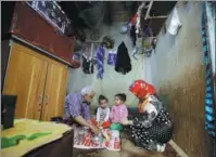  ?? NUSAIBAH ALMUAALEMI / REUTERS ?? Ahmad Farea and his family sit for a meal at their house in Sanaa, Yemen, on Thursday.