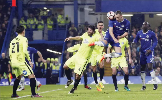  ??  ?? LONDON: Chelsea’s John Terry, top, heads the ball under pressure from Peterborou­gh United’s Michael Bostwick, center, during the English FA Cup third round soccer match between Chelsea and Peterborou­gh United at Stamford Bridge stadium in London,...