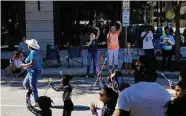  ?? Marie D. De Jesús/Staff photograph­er ?? Spectators wave at cheerleade­rs during Saturday’s Nigeria Cultural Parade and Festival downtown.