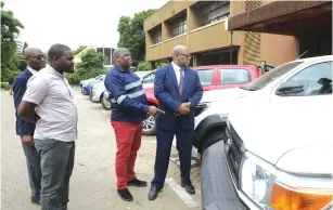  ?? ?? Local Government and Public Works Minister Winston Chitando (right), his deputy Benjamin Kabikira (left), the Ministry’s permanent secretary Dr John Basera (second from right) and chief director finance and administra­tion Emmanuel Ngwarati inspect motor vehicles that will be handed over to provinces to enhance service delivery in Harare yesterday.-— Picture: Memory Mangombe