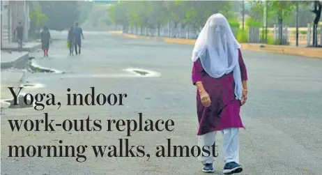  ?? PHOTO: DEEPAK GUPTA/HT ?? ■
COME WHAT MAY This Lucknowite refuses to compromise with her morning walk routine and saunters on a street, instead of her regular park, but fully protecting herself against coronaviru­s by covering her face.