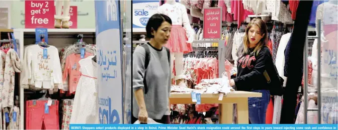  ??  ?? BEIRUT: Shoppers select products displayed in a shop in Beirut. Prime Minister Saad Hariri’s shock resignatio­n could unravel the first steps in years toward injecting some cash and confidence in Lebanon’s anemic economy. — AP