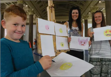  ??  ?? Ally Cullen, 8, from Lanark pictured in GOMA with visitors Jan Webb, left and Karen Young, both from Glasgow, who are holding the emoji drawings Ally did for them Pictures: Colin Mearns