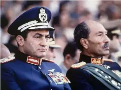  ?? (AP) ?? Vice President Mubarak (left) with President Anwar Sadat shortly before Sadat was assassinat­ed by soldiers during a parade in Cairo in October 1981