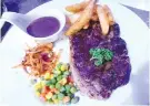  ??  ?? LAMB STEAK with potato wedges and onion salad.