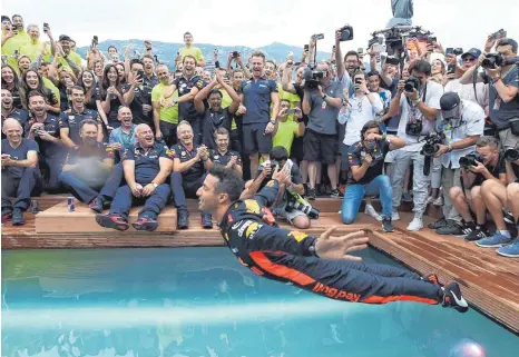  ?? FOTO: AFP ?? Wohlverdie­nte Erfrischun­g: Daniel Ricciardo feiert seinen Triumph beim Monte-Carlo-Grand-Prix mit einem Sprung in den Team-Pool.