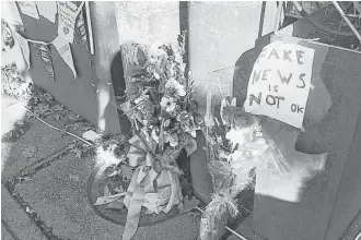  ?? Jessica Gresko / Associated Press ?? Flowers left by well-wishers rest outside Comet Ping Pong, the pizza restaurant in northwest Washington, D.C., where a North Carolina man allegedly fired an assault rifle multiple times as he attempted to “self-investigat­e” the conspiracy theory known...