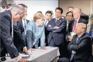  ?? PICTURE: REUTERS ?? German Chancellor Angela Merkel speaks to US President Donald Trump during the second day of the G7 meeting in Charlevoix city of La Malbaie, Quebec, Canada, this weekend.