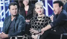  ??  ?? Luke Bryan, left, Katy Perry and Lionel Richie are the new judges on American Idol. The revived talent show is back on the air on March 11.