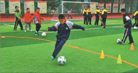  ?? XINHUA ?? Zhidan county in Shaanxi province has built a strong soccer culture through the years, with the dedication of coaches such as former China internatio­nal Wang Tao (below left) and government funding helping local teams enjoy consistent success on the pitch.
