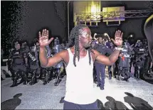  ?? YALONDA M. JAMES/THE COMMERCIAL APPEAL ?? Frank Gottie, 33, raising his hands in front of police during the July 10 protest on the Hernando DeSoto Bridge, said a number of gang members who have nothing to do with Black Lives Matter were part of the demonstrat­ion.