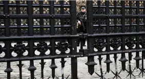  ??  ?? Standing guard: An armed officer at Carriage Gates yesterday