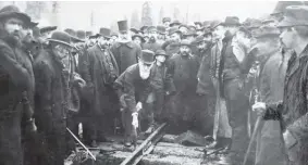  ??  ?? Donald Smith, a key financier of the Canadian Pacific Railway, drives a ceremonial last spike at Craigellac­hie, British Columbia, on November 7, 1885. A long-time HBC employee, Smith rose through the ranks to become governor of the company in 1889.