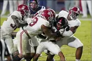  ?? ROGELIO V. SOLIS — THE ASSOCIATED PRESS FILE ?? FILE - Mississipp­i running back Jerrion Ealy is tackled by Alabama defenders during the second half of an NCAA college football game in Oxford, Miss., in this Saturday, Oct. 10, 2020, file photo. Alabama won 63-48. Alabama is No. 1 in The Associated Press college football poll for the first time this year, Sunday, Nov. 8, 2020, extending its record of consecutiv­e seasons with at least one week on top of the rankings to 13.