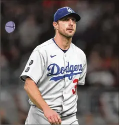  ?? AP FILE ?? Los Angeles Dodgers pitcher Max Scherzer leaves the field in Game 2 of the National League Championsh­ip Series against the Atlanta Braves on Oct. 17. Scherzer is a member of the MLB players union’s executive committee.