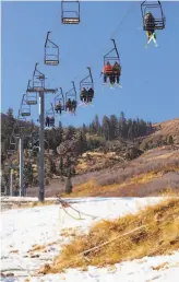  ??  ?? Top: Amie and Kamil Dusejovsky dressed as narwhals for opening day at Alpine Meadows Ski Resort in Placer County. Above: Dry, snowless slopes didn’t deter skiers seeking a respite from smoky skies to the west.