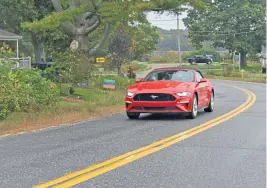  ?? STAFF PHOTOS BY JIM MAHONEY / BOSTON HERALD ?? FAMILIAR PROFILE: The Mustang GT convertibl­e’s features the classic pony-in-motion medallion.