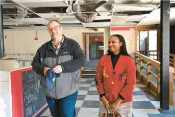  ?? LLOYD FOX/STAFF ?? Daniel Doty, with Hamilton-Lauraville Main Street, and Tammira Lucas, CEO of The Cube Cowork, inside the Markley building. The historic and vacant Markley Hotel will be redevelope­d into a center for retailers and other entreprene­urs as part of a larger effort to revitalize Harford Road.