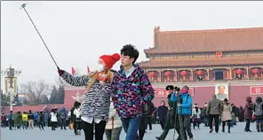  ?? PROVIDED TO CHINA DAILY ?? A couple take a photo with a selfie stick at the Tian’anmen Square in Beijing.