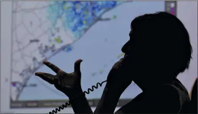  ?? The Associated Press ?? HURRICANE: A map of the Texas Coast is projected on a screen as Deb Nowinski, a disability integratio­n coordinato­r, gives informatio­n to a caller regarding the approach of Hurricane Harvey at the Galveston County Office of Emergency Management...