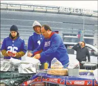  ?? Rich Graessle / Icon Sportswire via Getty Images ?? Giants and Jets fans tailgate prior to a game between the teams on Nov. 10 at MetLife Stadium in East Rutherford, NJ.