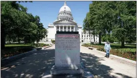  ?? (AP/Wisconsin State Journal/Steve Apps) ?? A pedestal that held the statue of Col. Hans Christian Heg, an anti-slavery activist who fought for the Union in the Civil War, stands empty Wednesday outside the state Capitol in Madison, Wis. The statue was toppled by protesters, decapitate­d and dragged into a lake about a half-mile away.