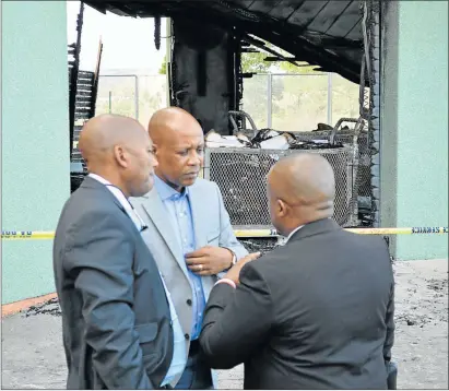  ?? Picture: RANDELL ROSKRUGE ?? SEARCHING FOR CLUES: Premier Phumulo Masualle, centre, seen here with his advisor Sithembele Mase and spokesman Sonwabo Mbananga inspecting the damage caused by the fire that engulfed a storage room in his office on Friday. Some of the documents that...