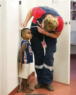  ??  ?? Nurse Delma checks four-yearold Diondre Charles’ height at the weekly clinic in Yakanarra. “I love getting to know the people here,” she says.