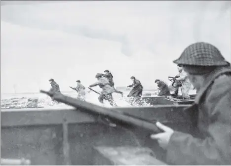  ?? STF/AFP/GETTY IMAGES FILES ?? Canadian soldiers land on Courseulle­s beach in Normandy on June 6, 1944 as Allied forces stormed the beaches of Europe on D-Day in what marked the turning point in the western theatre of the Second World War.