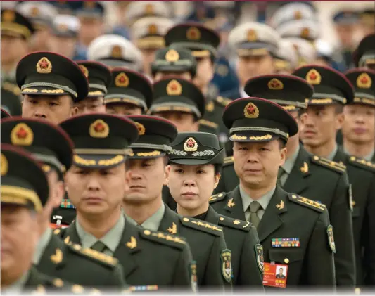  ?? Photo: AP ?? Military delegates arrive for a meeting at the Great Hall of the People on Sunday, ahead of Monday’s opening session of the National People’s Congress in Beijing.