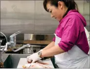  ?? YOSHIE MINAMIDANI - VIA THE ASSOCIATED PRESS, UNDATED ?? Yoshie Minamidani cuts a fish at her seafood store in Wajima, Ishikawa prefecture, Japan. She said Tuesday she is determined to bring Wajima back.