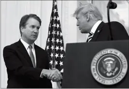  ?? ASSOCIATED PRESS ?? PRESIDENT DONALD TRUMP SHAKES HANDS with Supreme Court Justice Brett Kavanaugh before a ceremonial swearing in in the East Room of the White House in Washington on Monday.