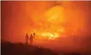  ?? Spain. Photograph: AFP/Getty Images ?? Firefighte­rs at the site of a wildfire between Navalacruz and Riofrio, central