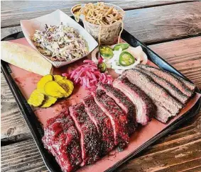  ?? Photos by J.C. Reid/Contributo­r ?? The menu at Round Top Smokehouse includes brisket, char siu baby back ribs, coleslaw, cold garlic noodles and more.