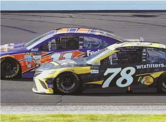  ?? AP PHOTO ?? WHEELY CLOSE: Martin Truex Jr. (78) battles Denny Hamlin at New Hampshire Motor Speedway yesterday during the Overton’s 301 in Loudon, N.H.