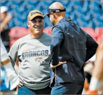  ?? JOSE M. OSORIO/CHICAGO TRIBUNE ?? Broncos coach Vic Fangio and Bears coach Matt Nagy talk before a game last season at Broncos Stadium at Mile High in Denver .