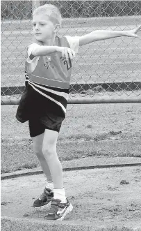  ??  ?? Above: Aaron Boughey looks poised in the under 9 discus event.