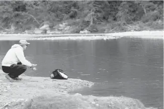  ?? Leah Hennel/calgary Herald ?? Teodor, a visitor from Romania, fishes on the Elbow River on Thursday. Teodor has been impressed with his first visit to Canada. “Calgary is super,” he says. “And good fishing.”