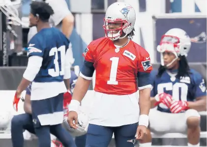  ?? MICHAEL DWYER/AP ?? Patriots quarterbac­k Cam Newton stands on the sidelines before a training camp scrimmage Aug. 28 in Foxborough, Mass.