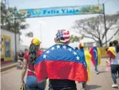  ?? RODRIGO ABD/AP ?? Larry Rios makes his way to the Venezuela Aid Live concert, near the Simon Bolivar Internatio­nal Bridge, in San Antonio del Tachira, Venezuela, on Friday.